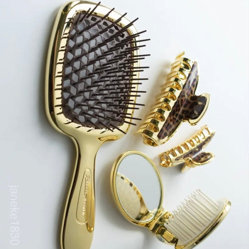Set of gold Janeke hairbrushes and styling tools on a light gray background