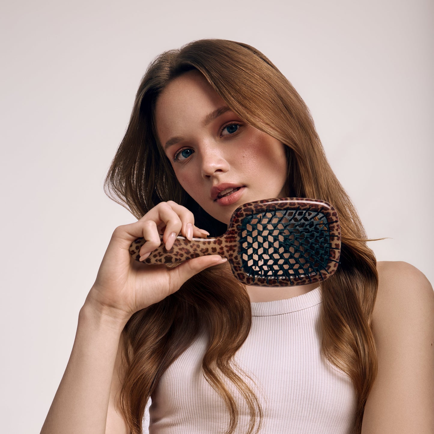 Woman holding a Janeke hairbrush with a leopard print