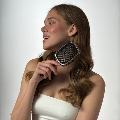 Woman holding a Janeke hairbrush with leopard  print 