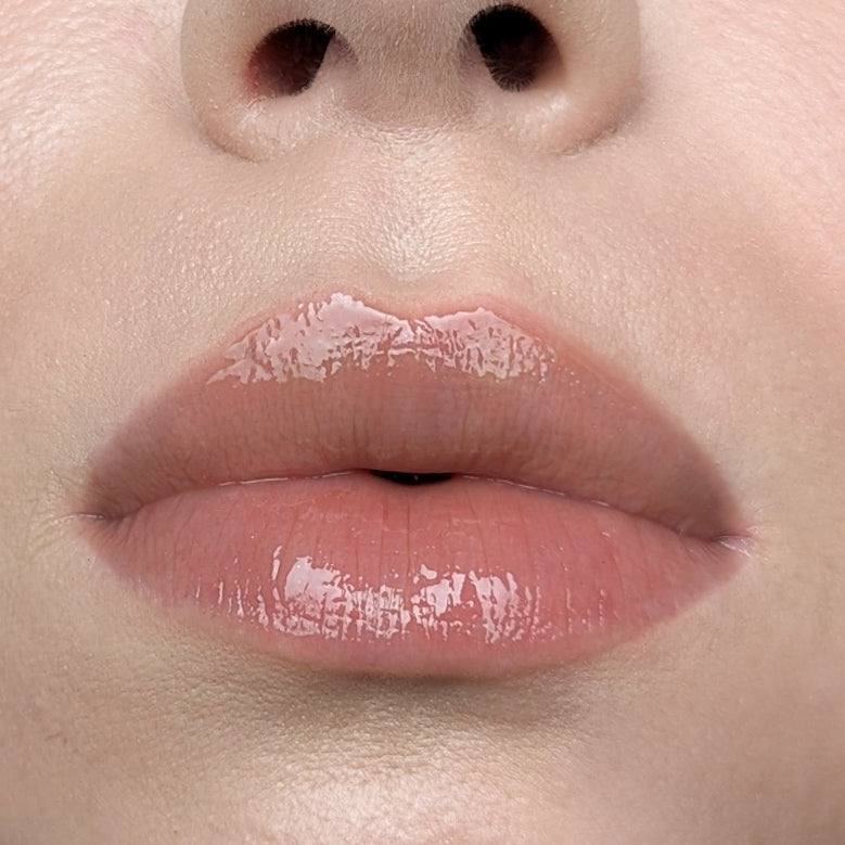Close-up of a person's lips with a glossy lip gloss Lipss Coffee