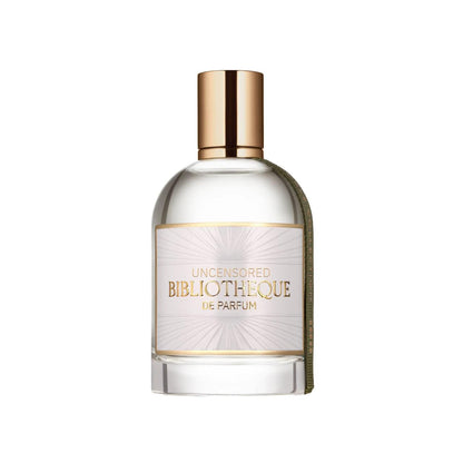 Perfume bottle with gold cap and label Bibliotheque de Parfum Uncensored on a white background