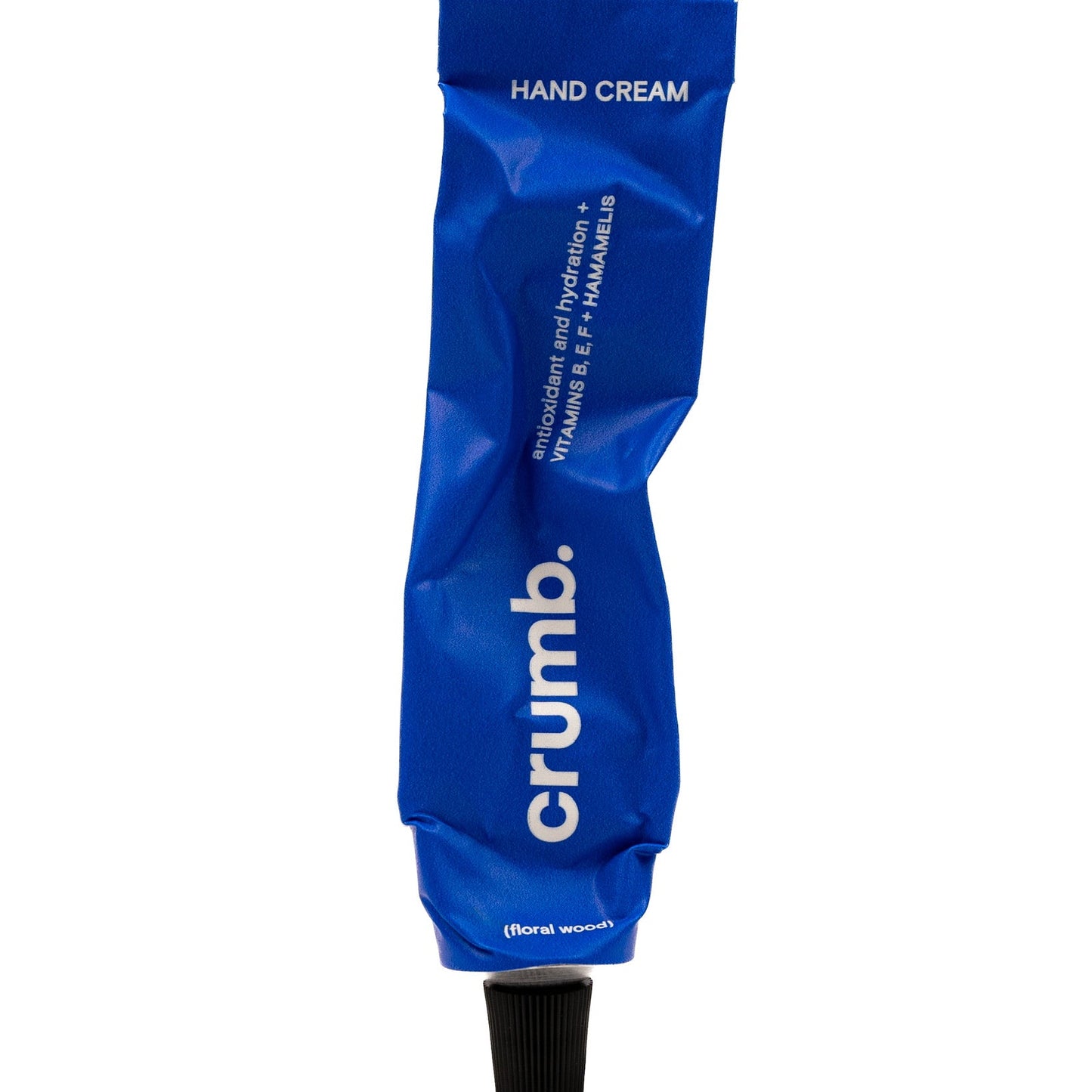 Blue tube of crumb hand cream floral wood on a white background