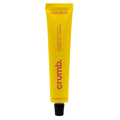 Yellow tube of crumb hand cream on a white background