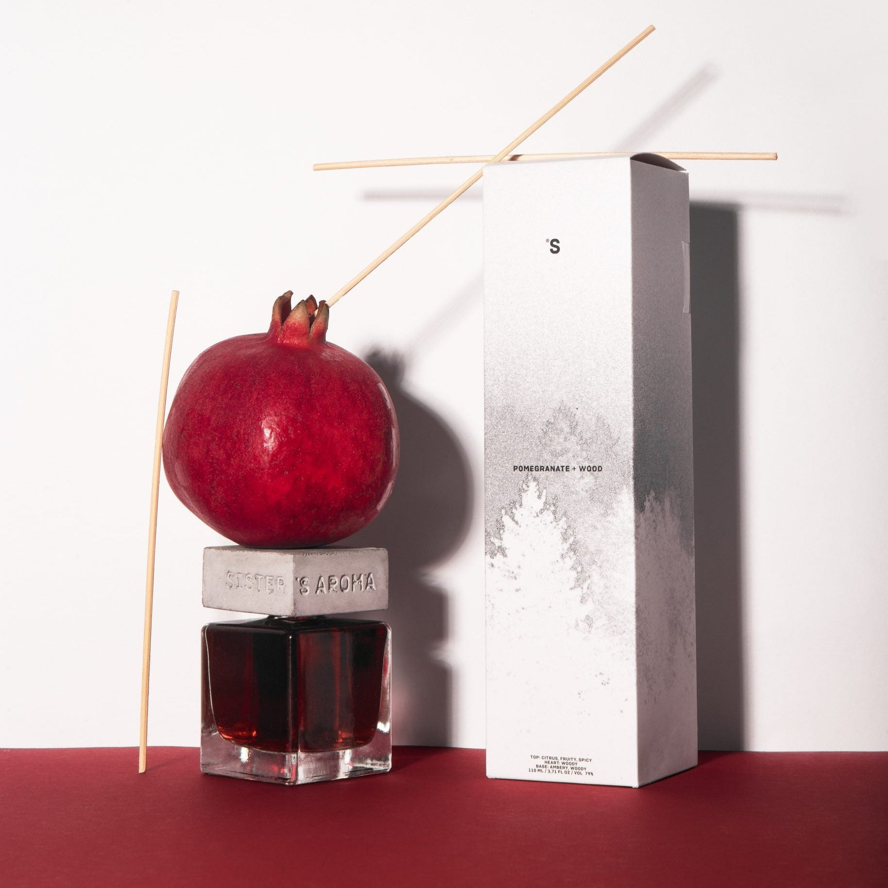 Home diffuser sister's aroma pomegranate + wood on a white background
