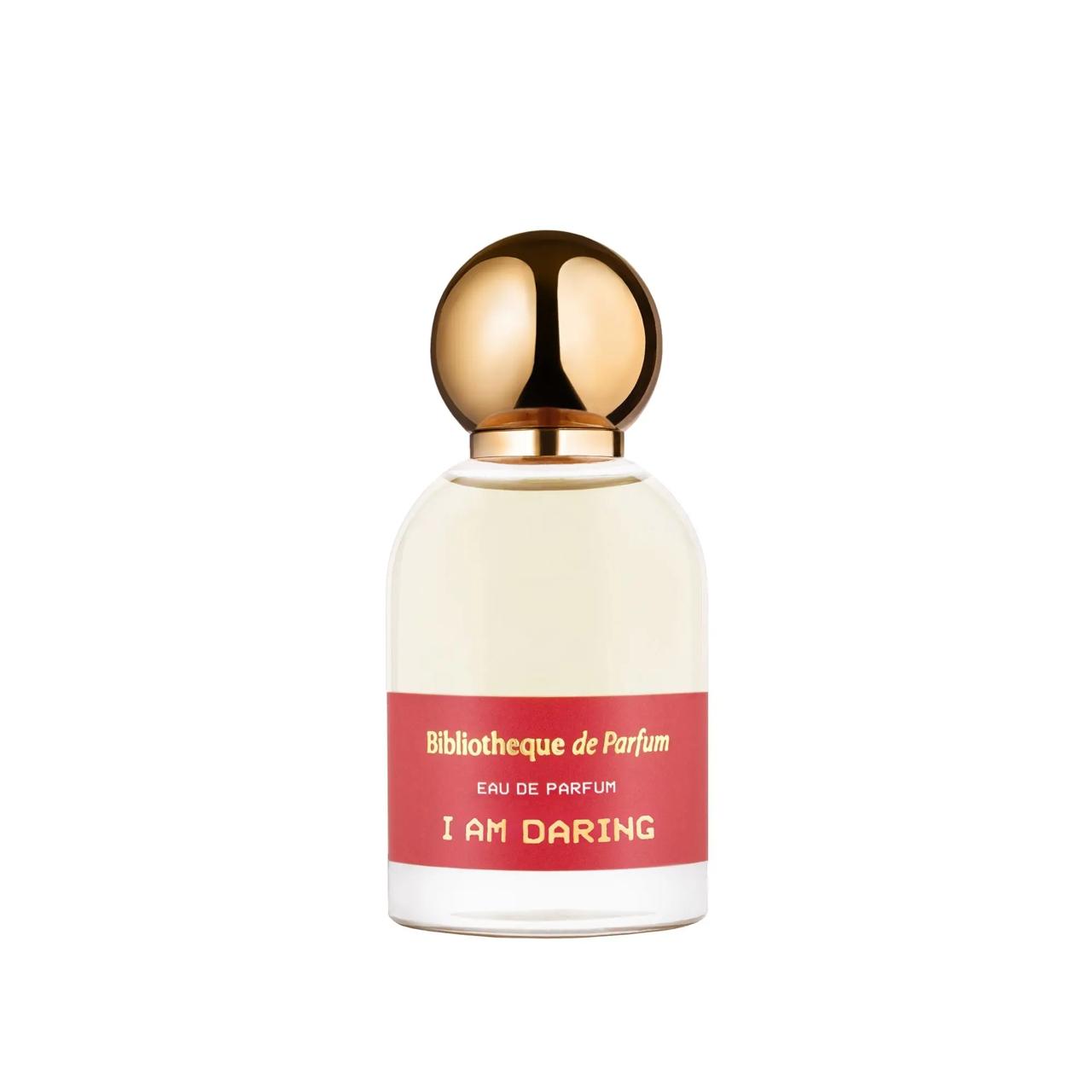 Perfume bottle with gold cap and red label Bibliotheque de Parfum I am Daring on a white background