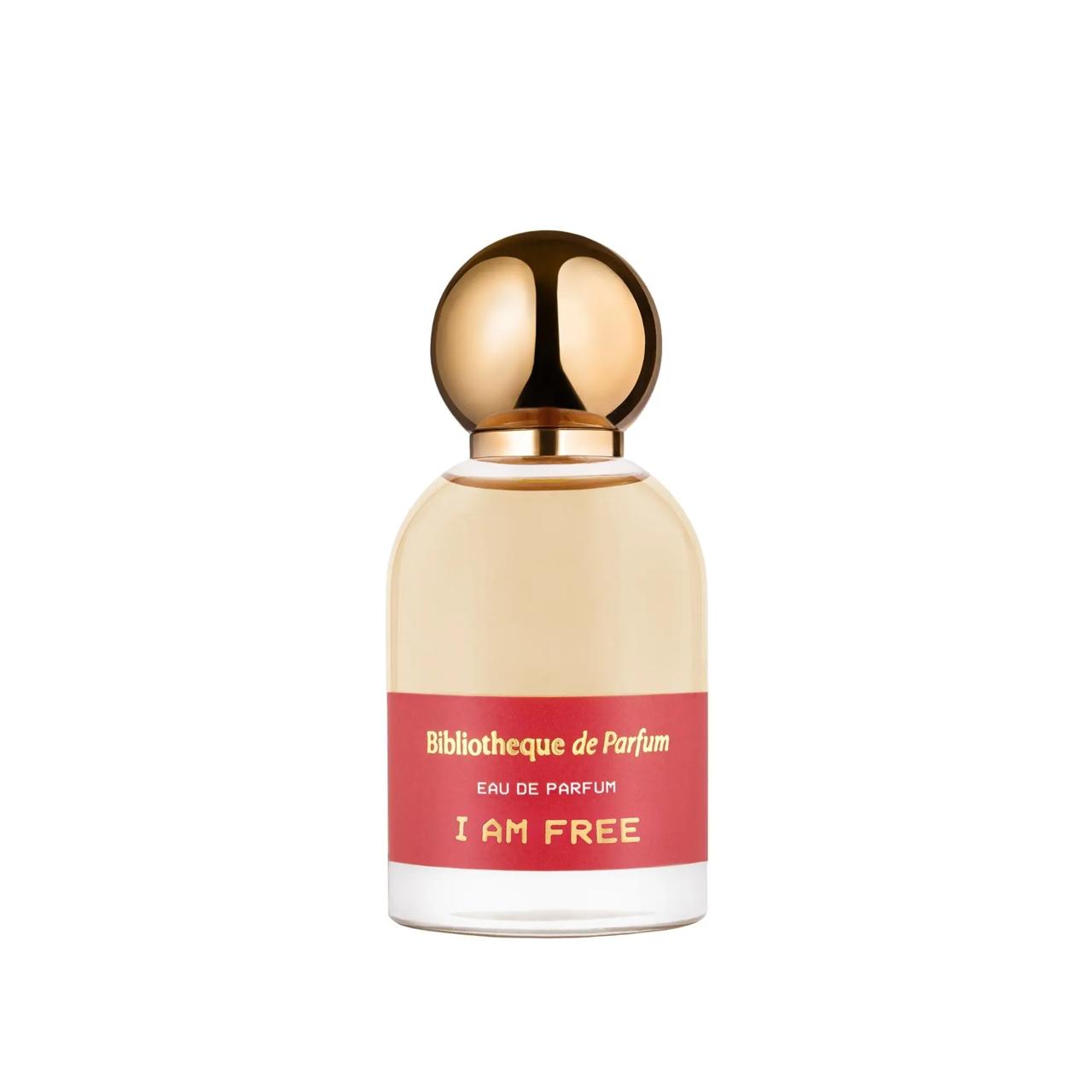 Perfume bottle with gold cap and red label   Bibliotheque de Parfum I am Free on a white background