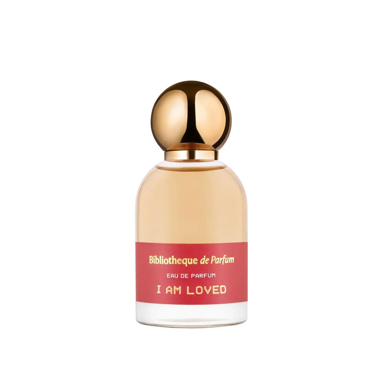 Perfume bottle with gold cap and red label  Bibliotheque de Parfum I am Loved on a white background