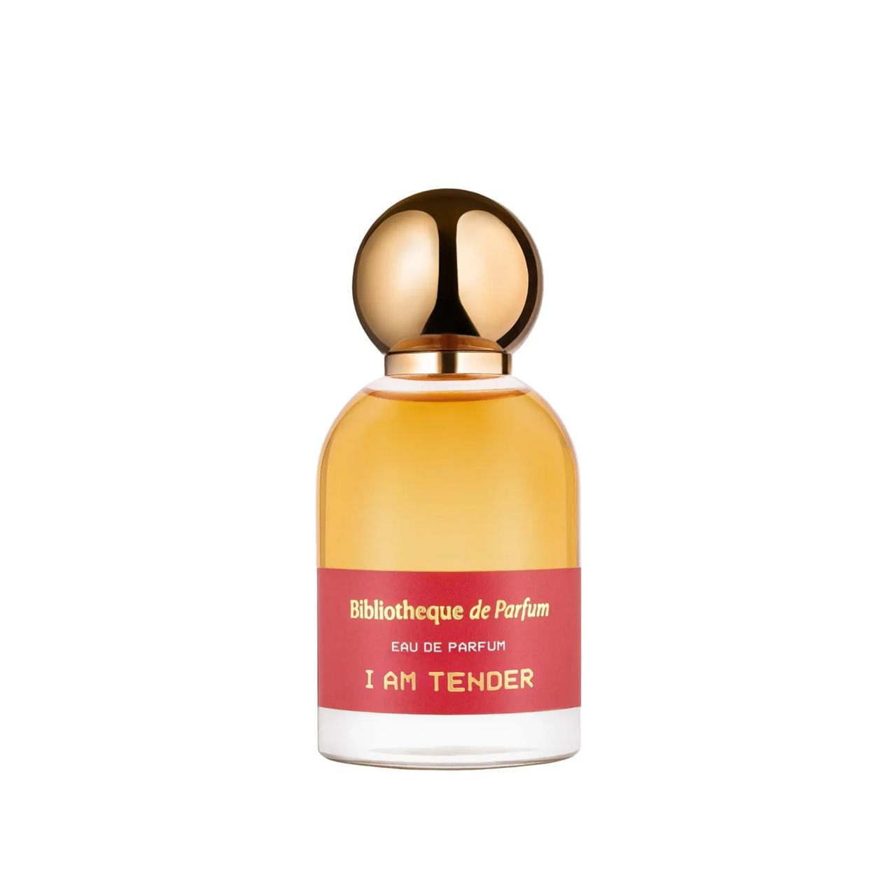 Perfume bottle with gold cap and red label  Bibliotheque de Parfum I an tender on a white backgrounde