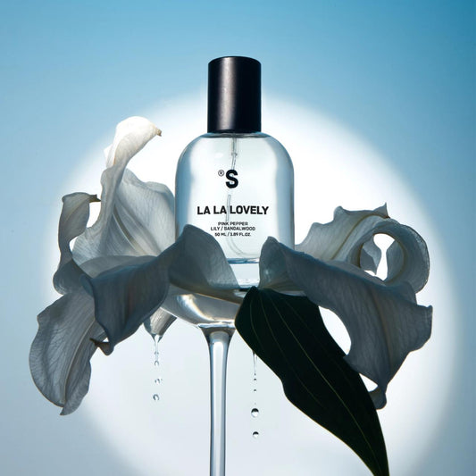 Sister's Aroma perfume 'LA LA LOVELY' with flowers in the background